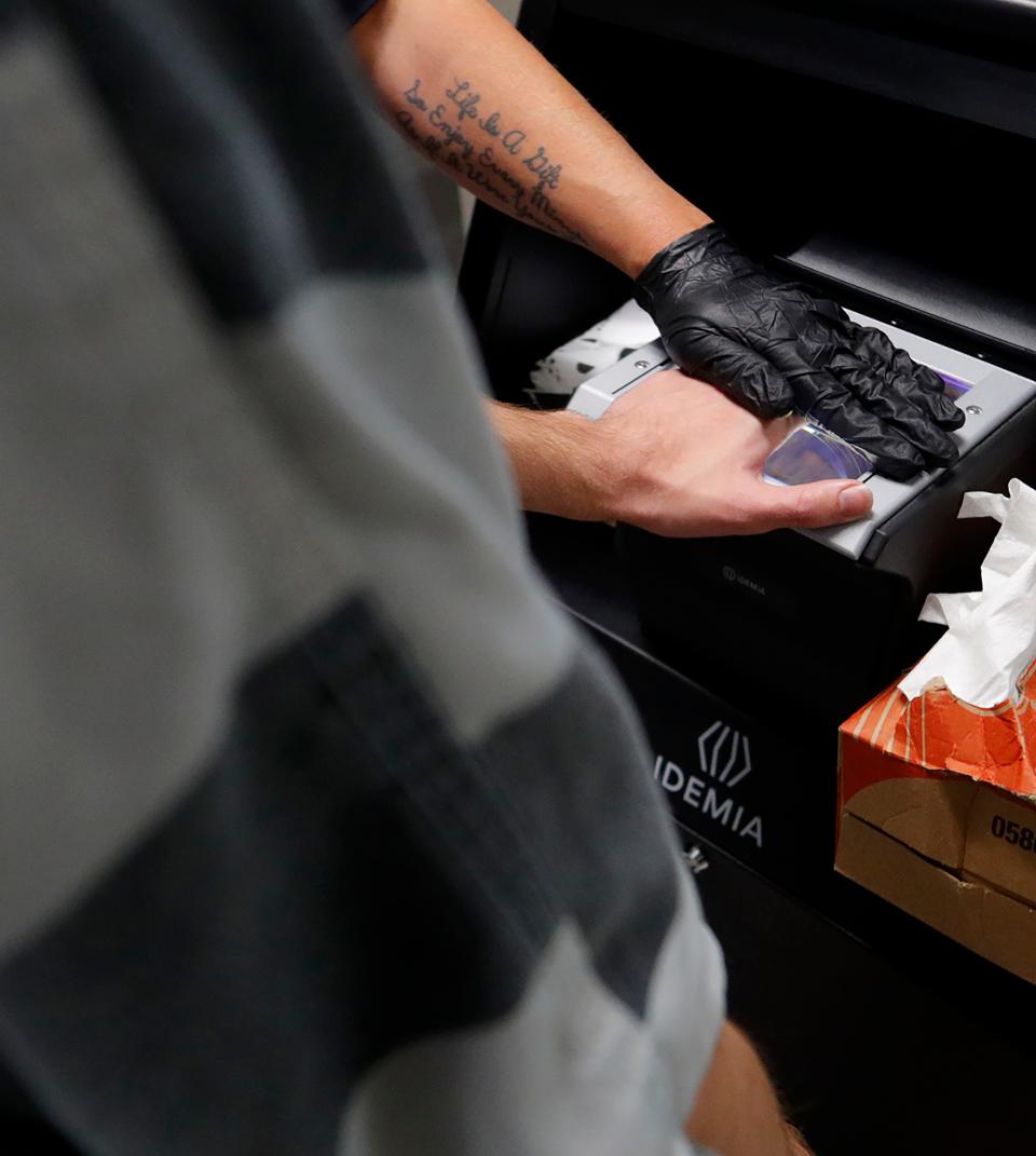 A prisoner gets his fingerprints taken at the Oldham County Detention Center.
June 15, 2023