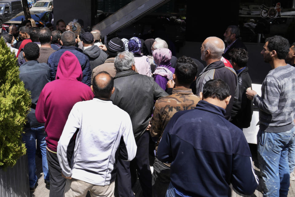FILE - Lebanese and Syrian citizens queue for bread outside a bakery, in the southern suburb of Beirut, Lebanon, Tuesday, April 12, 2022. Russia’s war in Ukraine has threatened food supplies in countries like Lebanon, which has the world's highest rate of food inflation, 122%, and depends on the Black Sea region for nearly all of its wheat. The Razoni, loaded up with 26,000 tons of corn, is the first cargo ship to leave Ukraine since the Russian invasion, and set sail from Odesa Monday, August 1, 2022. Its final destination is Lebanon, with estimated arrival date on Saturday, Aug. 6, 2022. (AP Photo/Hussein Malla, File)