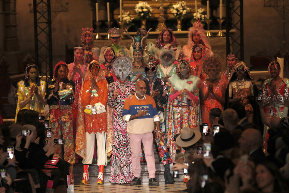 Designer Manish Arora, centre, accepts applause as he poses with models after his ready to wear Fall-Winter 2019-2020 collection, that was presented in Paris, Thursday, Feb. 28, 2019. (AP Photo/Christophe Ena)