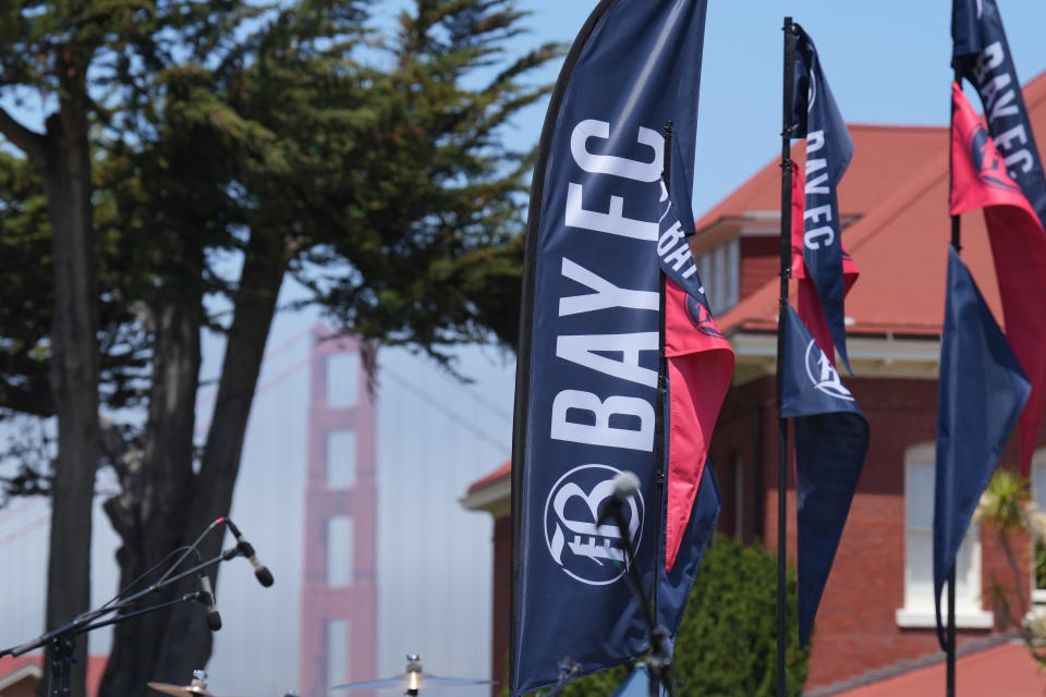 Jun 3, 2023; San Francisco, California, USA; Bay FC flags fly as the Golden Gate Bridge stands in the background before the Bay FC Day for the Bay event at Presidio Main Post Lawn. Mandatory Credit: Darren Yamashita-USA TODAY Sports