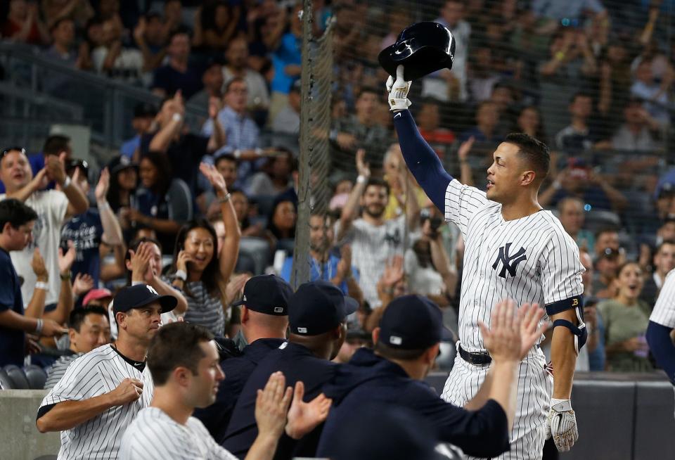New York Yankees' Giancarlo Stanton takes a curtain call after his two-run home run in the third inning against the Detroit Tigers at Yankee Stadium on Aug. 30, 2018. The home run was Stanton's 300th in the majors.