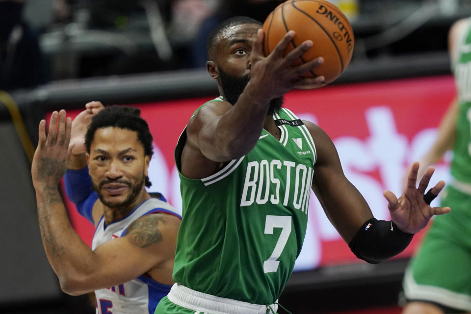 Boston Celtics guard Jaylen Brown (7) makes a layup as Detroit Pistons guard Derrick Rose defends during the first half of an NBA basketball game Friday, Jan. 1, 2021, in Detroit. (AP Photo/Carlos Osorio)