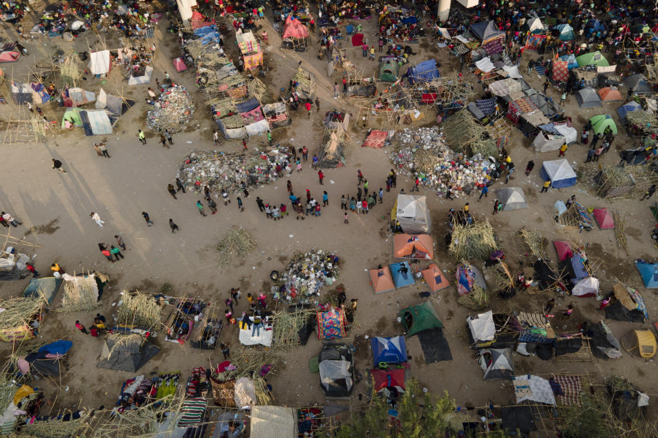 FILE - Migrants, many from Haiti, are seen at an encampment along the Del Rio International Bridge near the Rio Grande, Sept. 21, 2021, in Del Rio, Texas. About 15,000 mostly Haitian refugees were camped under the bridge in the small border town. (AP Photo/Julio Cortez)