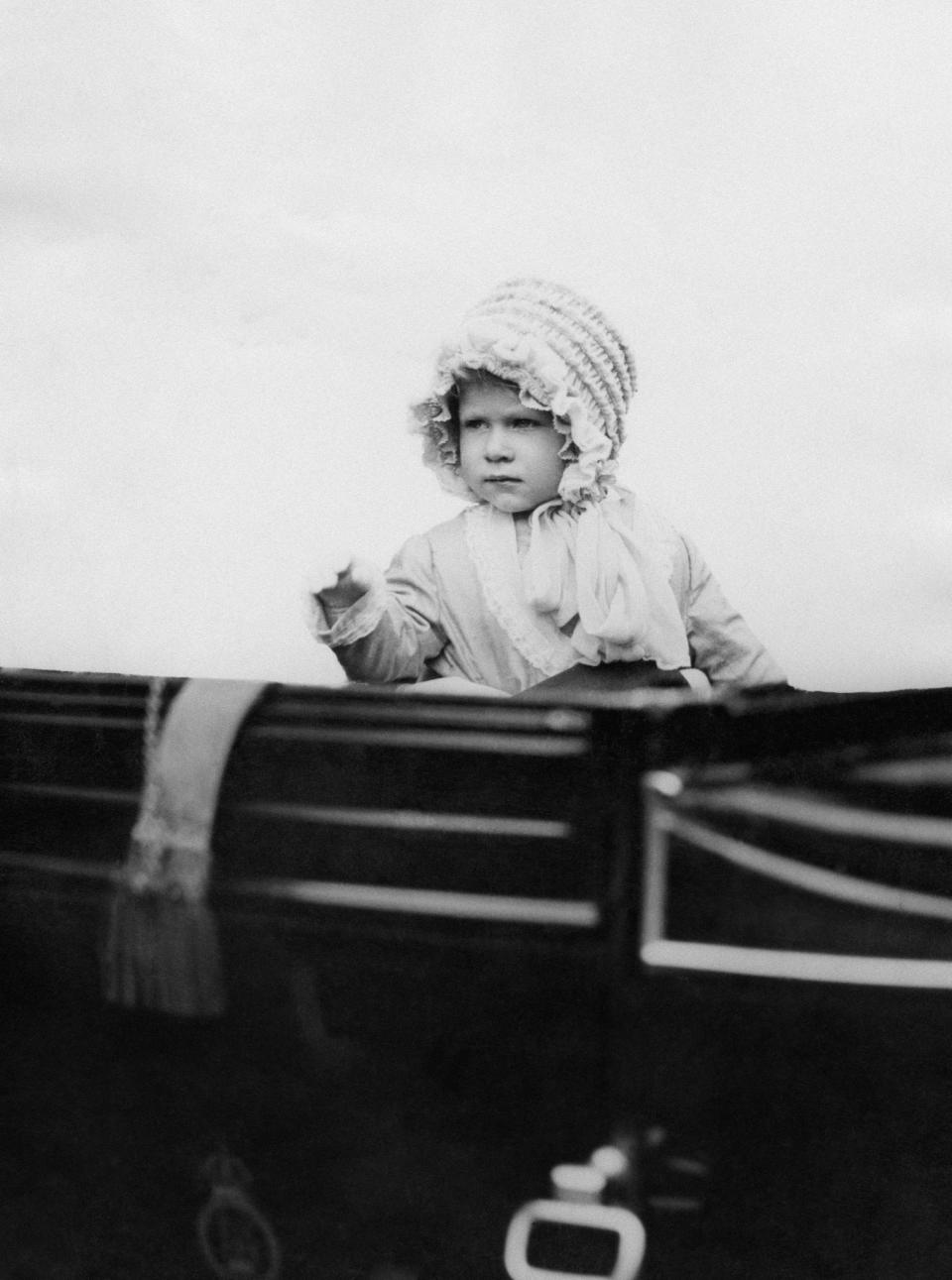 <p>Is it just us or does a two-year old Queen Elizabeth look just like Prince Harry when he was a boy? [Photo: PA Images] </p>