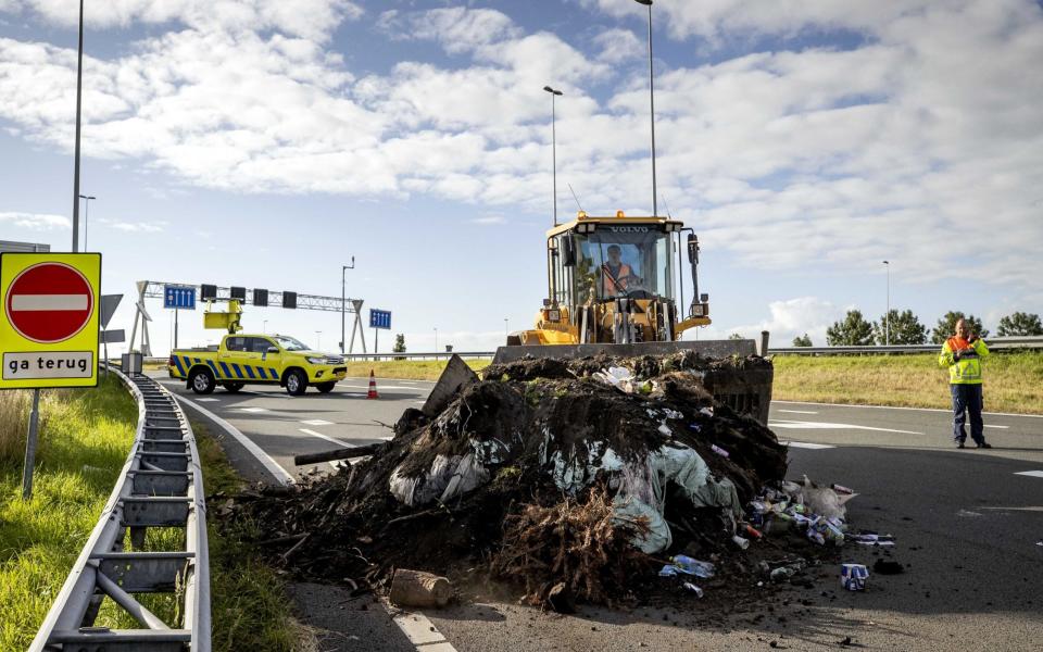 Workers clean debris during farmer protest in the Netherlands - SEM VAN DER WAL/EPA-EFE/Shutterstock