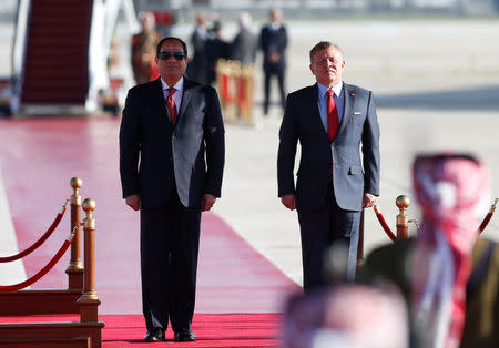 Jordan's King Abdullah II stands next to Egypt's President Abdel Fattah al-Sisi during a reception ceremony at the Queen Alia International Airport in Amman, Jordan March 28, 2017. REUTERS/Muhammad Hamed