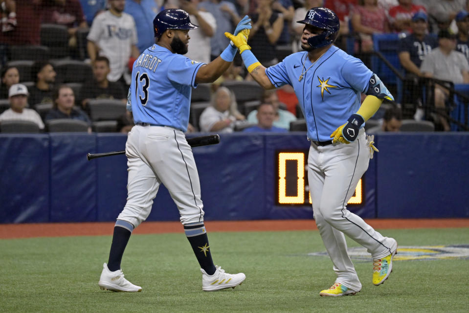 Tampa Bay Rays' Manuel Margot, left, congratulates Isaac Paredes, right, after Paredes hit a solo home run off Philadelphia Phillies starter Cristopher Sanchez during the fifth inning of a baseball game Thursday, July 6, 2023, in St. Petersburg, Fla. (AP Photo/Steve Nesius)