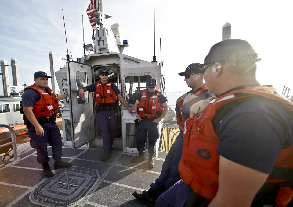 This photo taken Jan. 28, 2014, shows the crew of a 45 foot Coast Guard patrol boat runs through their pre-departure briefing in San Diego harbor in San Diego. Once the vessel exited the harbor area it encountered a dense fog. With the drug war locking down land routes across Latin America and at the U.S. border, smugglers have been increasingly using large vessels to carry multi-ton loads of cocaine and marijuana hundreds of miles offshore where the lead federal agency with extensive law enforcement powers is the Coast Guard, a military service roughly the size of the New York Police Department. (AP Photo/Lenny Ignelzi)