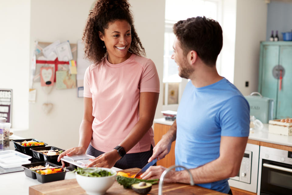 Couple batch cooking together in the kitchen