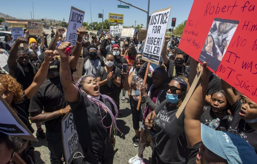 PALMDALE, CA - JUNE 13: Paris Draper, left, leads hundreds of protesters in chants for justice after the death of a young Black man, Robert Fuller, during protest march in Palmdale on Saturday, June 13, 2020 in Palmdale, CA. (Brian van der Brug / Los Angeles Times)