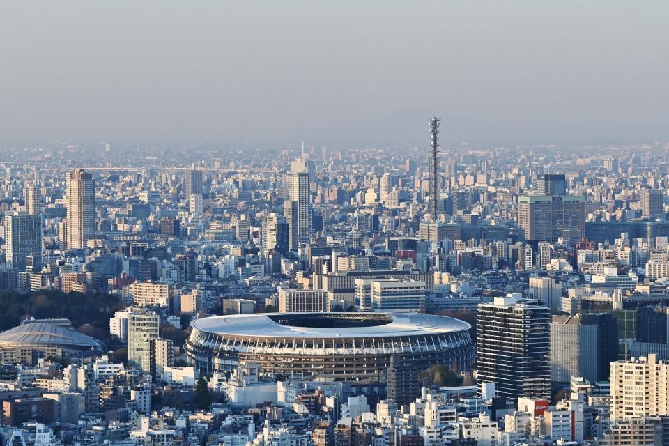 The newly-built Japan National Stadium, the main venue for the 2020 Olympic Games, is pictured from a highrise viewing area in Tokyo on March 25, 2020, the day after the historic decision to postpone the 2020 Tokyo Olympic Games. - Japan on March 25 started the unprecedented task of reorganising the Tokyo Olympics after the historic decision to postpone the world's biggest sporting event due to the COVID-19 coronavirus pandemic that has locked down one third of the planet. (Photo by CHARLY TRIBALLEAU / AFP) (Photo by CHARLY TRIBALLEAU/AFP via Getty Images)