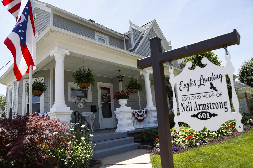 The boyhood home of astronaut Neil Armstrong is commemorated by a sign on its front yard, Wednesday, June 26, 2019, in Wapakoneta, Ohio. Very down to earth about most things, folks in this small western Ohio city are over the moon as they get ready to celebrate the 50th anniversary of the day they watched their hometown hero along with the world. Neil Armstrong put Wapakoneta on the map in July 1969 when he became the first human to walk on the moon. (AP Photo/John Minchillo)