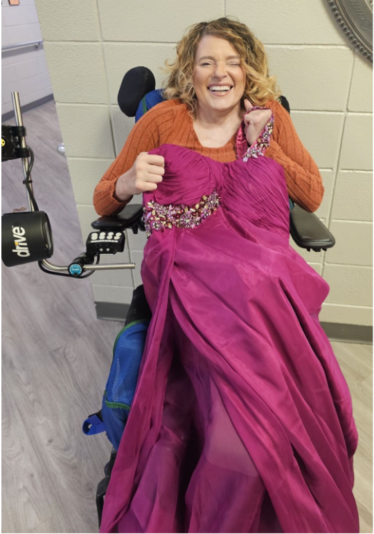 Laura Holder, 51, holds the prom dress she will wear to The Ivy at Gastonia's May prom.