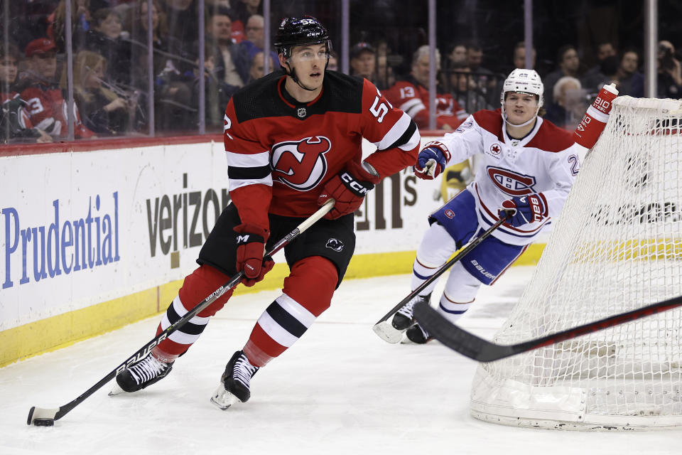 FILE - New Jersey Devils defenseman Cal Foote (52) skates with the puck against the Montreal Canadiens during the first period of an NHL hockey game Jan. 17, 2024, in Newark, N.J. Four current members of the National Hockey League charged with sexual assault in Canada will become free agents after not receiving qualifying offers from their respective teams. Carter Hart was under contract with Philadelphia, Michael McLeod and Foote with New Jersey and Dillon Dube with Calgary when they were charged in connection with an incident that occurred in London, Ontario, in 2018 after they were teammates on Canada's world junior team. (AP Photo/Adam Hunger, File)