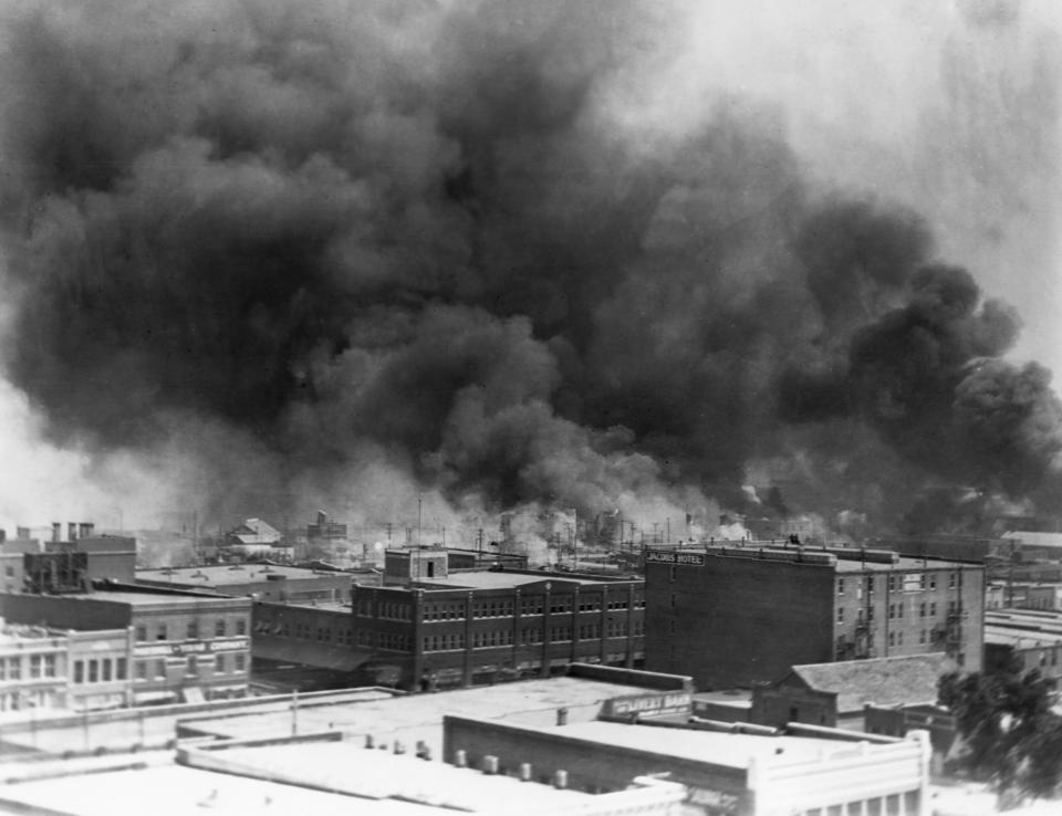 Black smoke billows from fires during the race riot of 1921 in Tulsa, Oklahoma. (Photo by © CORBIS/Corbis via Getty Images)