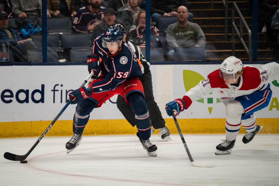 Nov 29, 2023; Columbus, Ohio, USA;
Columbus Blue Jackets right wing Yegor Chinakhov (59) gets the puck against Montreal Canadiens defenseman Kaiden Guhle (21) during the first period of their game on Wednesday, Nov. 29, 2023 at Nationwide Arena.