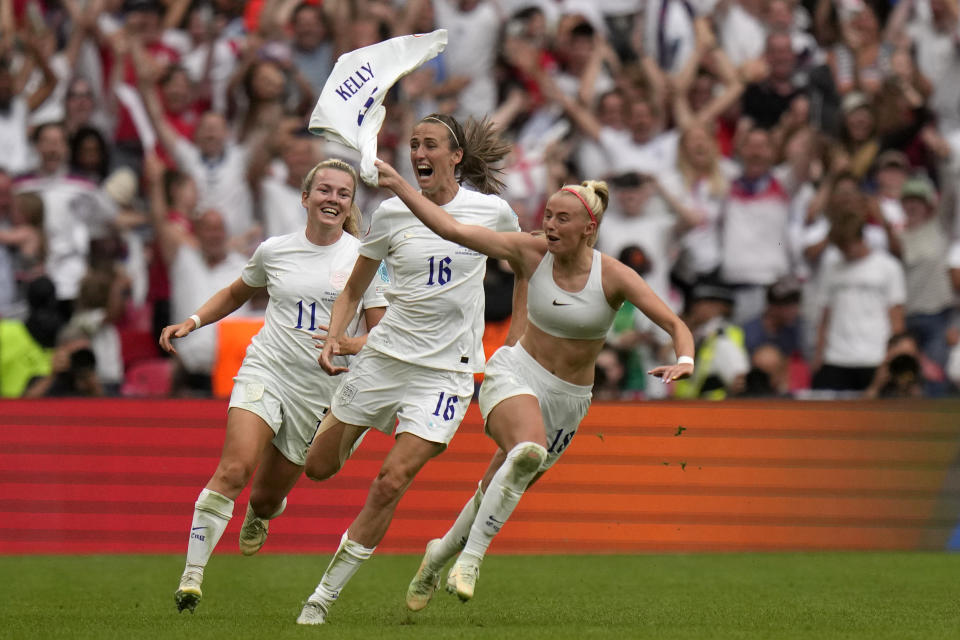 England's Chloe Kelly, right, celebrates after scoring her side's second goal during the Women's Euro 2022 final soccer match between England and Germany at Wembley stadium in London, Sunday, July 31, 2022. (AP Photo/Alessandra Tarantino)