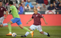 Colorado Rapids forward Michael Barrios, right, passes the ball between the legs of Seattle Sounders defender Xavier Arreaga in the second half of an MLS soccer match, Sunday, May 22 2022, in Commerce City, Colo. (AP Photo/David Zalubowski)