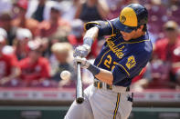 Milwaukee Brewers' Christian Yelich (22) hits a home run during the seventh inning of a baseball game against the Cincinnati Reds in Cincinnati, Sunday, July 18, 2021. (AP Photo/Bryan Woolston)