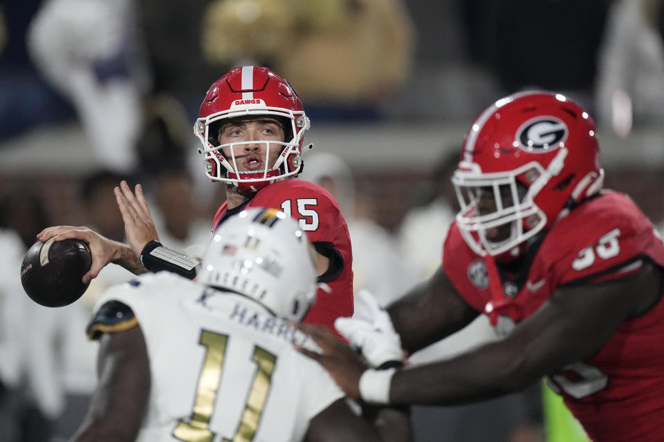 Georgia quarterback Carson Beck (15) throws from the pocket during the first half of an NCAA college football game against Georgia Tech, Saturday, Nov. 25, 2023, in Atlanta. (AP Photo/John Bazemore)