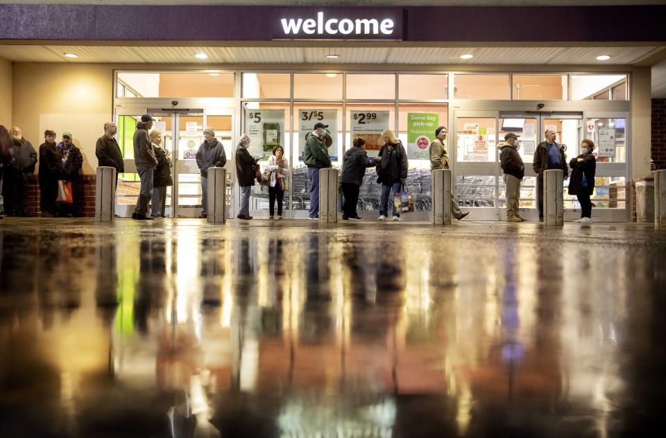 Shoppers wait in line to enter a Stop & Shop supermarket during hours open daily only for seniors, March 19, 2020, in North Providence, R.I. (AP Photo/David Goldman)