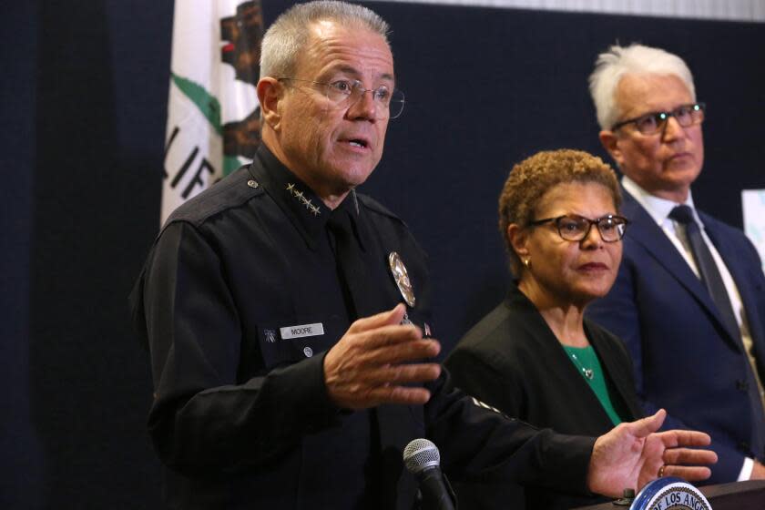 LOS ANGELES, CA - DECEMBER 1, 2023 - LAPD Chief Michael Moore, from left, alongside Los Angeles Mayor Karen Bass and Los Angeles District Attorney George Gascon, discusses the recent murders of three homeless men by a suspected serial killer at the LAPD Headquarters in downtown Los Angeles on December 1, 2023. (Genaro Molina / Los Angeles Times)