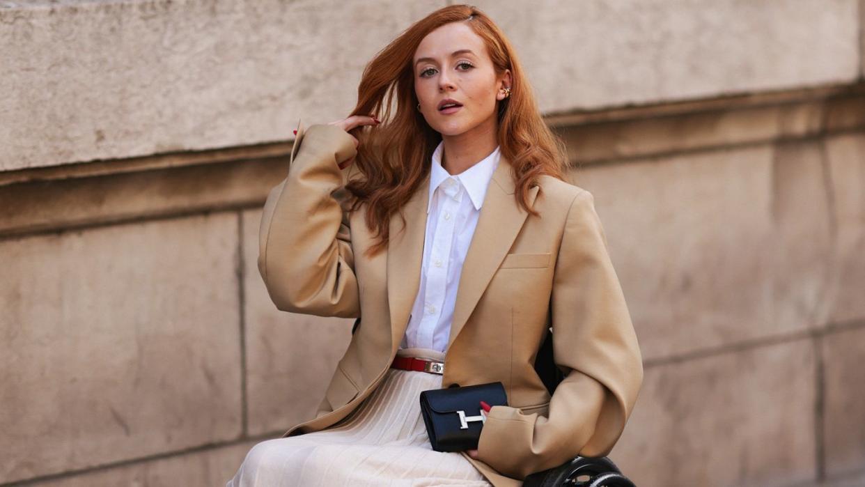 a person sitting on a ledge with a wallet