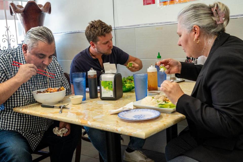 Bryan Emery and Kevin Pettersson eat lunch with a coworker at Com Tam Dat Thanh in south Sacramento on Thursday, July 18, 2024.