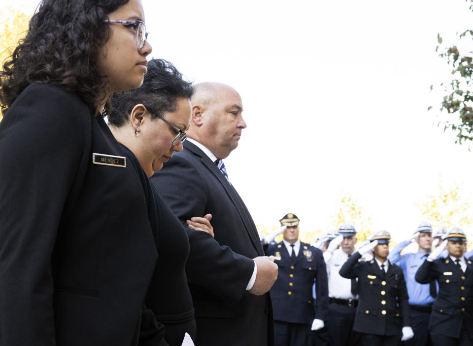 Alex Mendez, second left, arrives for the viewing of her husband, officer Richard Mendez, alongside their daughter Mia Mendez at the Cathedral Basilica of Saints Peter and Paul in Philadelphia, Tuesday, Oct. 24, 2023. Mendez was shot and killed, and a second officer was wounded when they confronted people breaking into a car at Philadelphia International Airport, Oct. 12, police said. (AP Photo/Joe Lamberti)