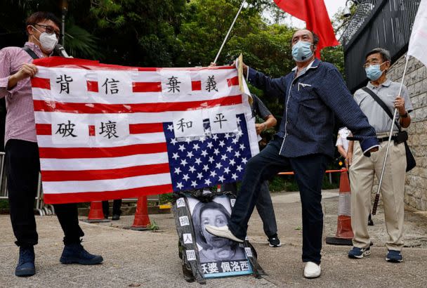 PHOTO: A pro-China supporter steps on a defaced photo of U.S. House of Representatives Speaker Nancy Pelosi during a protest against her visit to Taiwan outside the Consulate General of the United States in Hong Kong, China, Aug. 3, 2022.  (Tyrone Siu/Reuters)