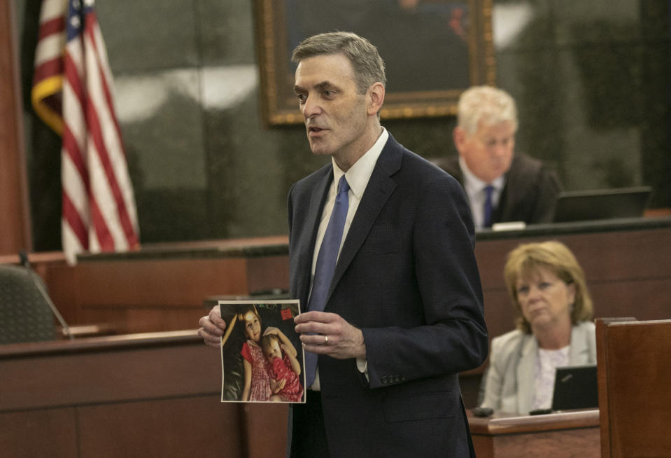 11th Circuit Solicitor Rick Hubbard delivers closing arguments, showing pictures of the Jones children during the sentencing phase of the trial of Timothy Jones Jr. in Lexington, S.C. on Thursday, June 13, 2019. Jones, Jr. was found guilty of killing his five young children in 2014. (Tracy Glantz/The State via AP, Pool)