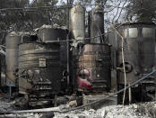 <p>Damaged wine making vats and tanks due to a wildfire stand in ashes and debris at the production house of Paradise Ridge Winery on Tuesday, Oct. 10, 2017 in Santa Rosa, Calif. (Photo: Ben Margot/AP) </p>