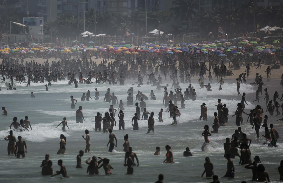People enjoy the Ipanema beach amid the new coronavirus pandemic in Rio de Janeiro, Brazil, Sunday, Sept.6, 2020. Brazilians are packing the beaches and bars this weekend, taking advantage of a long holiday to indulge in normal life even as the COVID-19 pandemic rages on. (AP Photo/Bruna Prado)