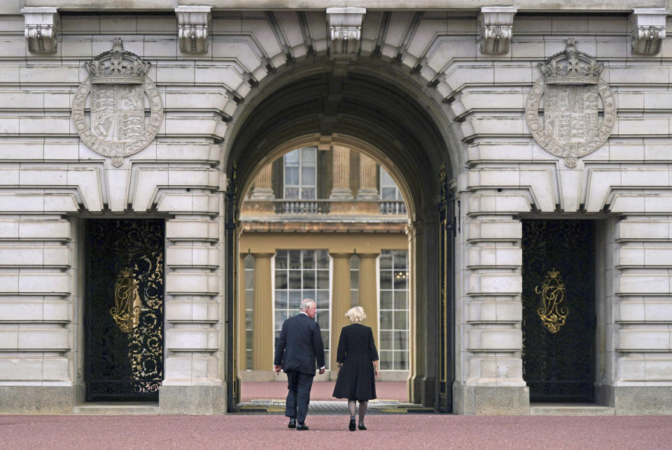 FILE - Britain's King Charles III, left, and Camilla, the Queen Consort, walk across the forecourt of Buckingham Palace, as he enters the palace for the first time as king, following Thursday's death of Queen Elizabeth II, in London, Friday, Sept. 9, 2022. (Yui Mok/Pool Photo via AP, File)