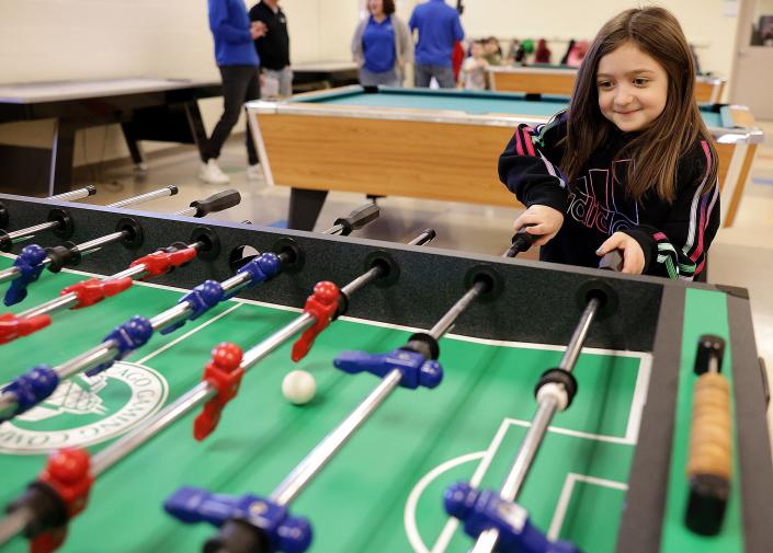 Seven-year-old Dani Forrer plays a game of table football recently at the Massillon Boys and Girls Club in Massillon.