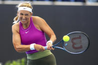 Belarus' Victoria Azarenka makes a backhand return to China's Qinwen Zheng during their Round of 16 match at the Adelaide International Tennis tournament in Adelaide, Australia, Thursday, Jan. 5, 2023. (AP Photo/Kelly Barnes)