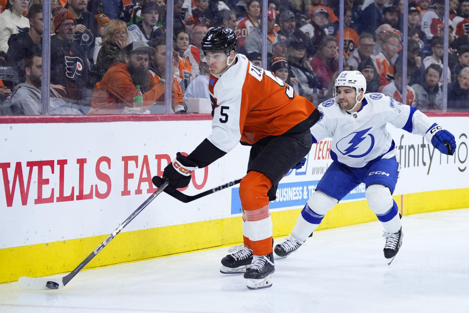 Philadelphia Flyers' Egor Zamula, left, tries to keep the puck away from Tampa Bay Lightning's Conor Sheary during the third period of an NHL hockey game, Tuesday, Feb. 27, 2024, in Philadelphia. (AP Photo/Matt Slocum)