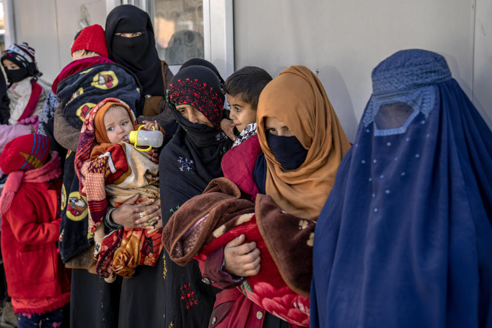 Mothers along with babies who suffer from malnutrition wait to receive help and check-up at a clinic that run by the WFP, in Kabul, Afghanistan, Thursday, Jan. 26, 2023. A spokesman for the U.N. food agency says malnutrition rates in Afghanistan are at record highs. Aid agencies have been providing food, education, healthcare and other critical support to people, but distribution has been severely impacted by a Taliban edict banning women from working at national and international nongovernmental groups. (AP Photo/Ebrahim Noroozi)