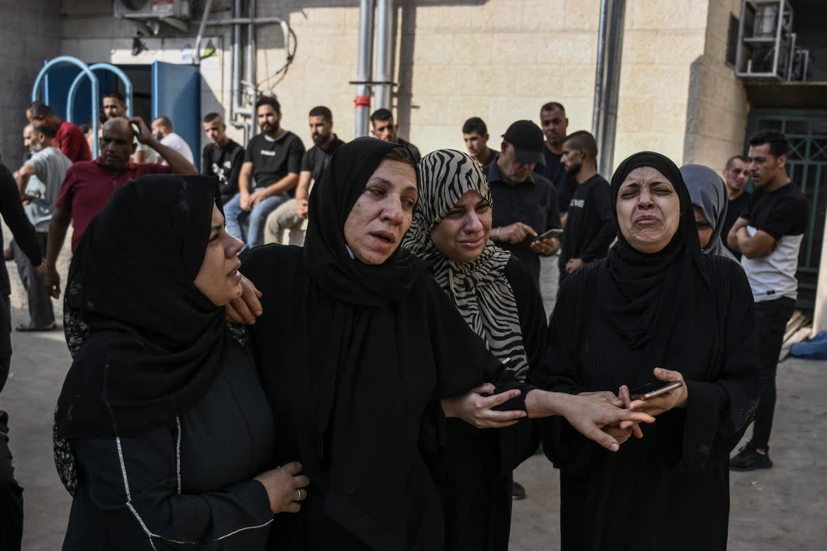 Palestinian relatives  outside Jenin Hospital before a funeral of a man killed in the city  (AFP via Getty Images)