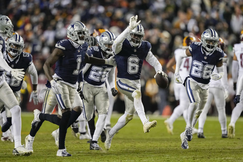 Dallas Cowboys safety Donovan Wilson (6) celebrates his interception against the Washington Commanders with teammates during the first half of an NFL football game, Sunday, Jan. 7, 2024, in Landover, Md. (AP Photo/Susan Walsh)