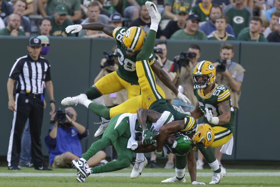 Green Bay Packers' Bronson Kaufusi stops New York Jets' Keelan Cole during the second half of a preseason NFL football game Saturday, Aug. 21, 2021, in Green Bay, Wis. (AP Photo/Matt Ludtke)