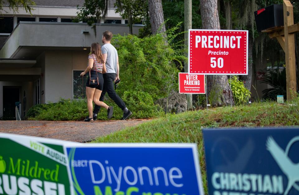 Iren Tete, 31, and fiance Jesse Ring, 38, both University of Florida professors, walk inside Westminster Presbyterian Church to vote in the Primary Election on Tuesday, Aug. 23, 2022. "I wish we didn't have part-affiliated ballots," Ring said. "There are some exciting progressive candidates."