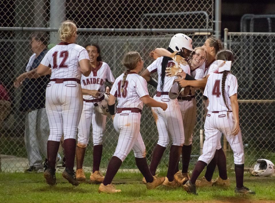 The Raiders celebrate their walk off 2-1 win in the bottom of the 7th inning during the Gulf Breeze vs Navarre softball game at Navarre High School on Tuesday, April 26, 2022.