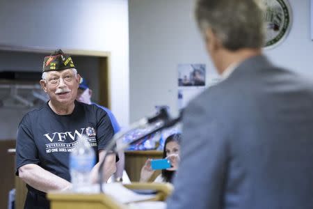 Scott Brown, a Republican candidate for the U.S. Senate, listens to a question from the audience during a town hall campaign stop at a VFW post in Hudson, New Hampshire September 3, 2014. REUTERS/Brian Snyder