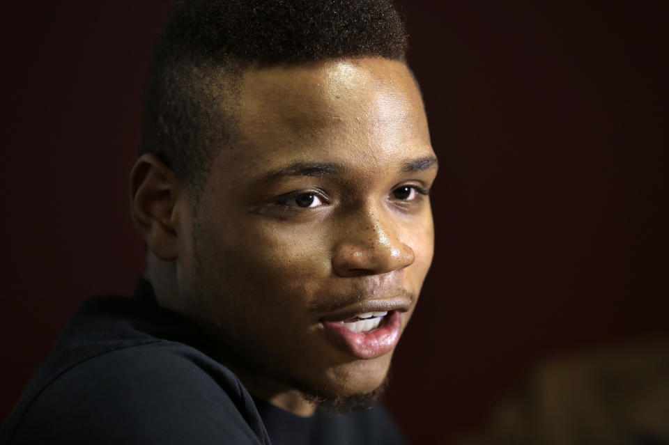 University of Massachusetts basketball guard Derrick Gordon talks with reporters on the school's campus, Wednesday, April 9, 2014, in Amherst, Mass. Gordon hopes his decision to become the first openly gay player in Division I men's basketball will inspire others. (AP Photo/Steven Senne)