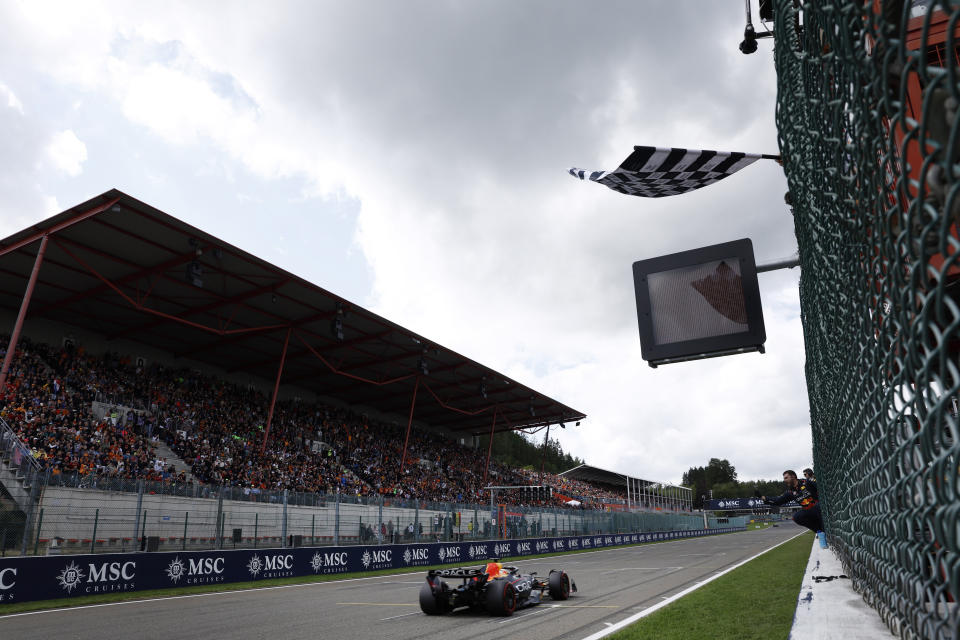 Red Bull driver Max Verstappen of the Netherlands receives the checkered flag as he crosses the finish line to win the Formula One Grand Prix at the Spa-Francorchamps racetrack in Spa, Belgium, Sunday, July 30, 2023. (Simon Wohlfahrt, Pool Photo via AP)