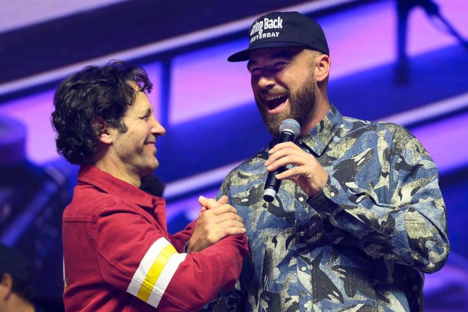 Big Slick co-host Paul Rudd, left, and Chiefs star Travis Kelce celebrate a win by their team in the hot wings trivia contest at the Big Slick Party & Show.