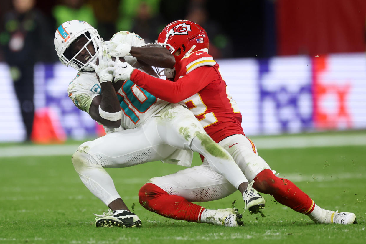 Tyreek Hill of the Miami Dolphins is tackled by Trent McDuffie of the Kansas City Chiefs in a meeting earlier this season. (Photo by Alex Grimm/Getty Images)