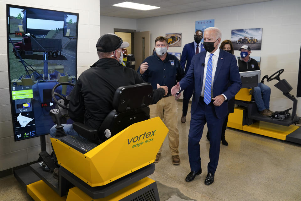 President Joe Biden tours the International Union Of Operating Engineers Local 324 training facility, Tuesday, Oct. 5, 2021, in Howell, Mich. Biden is joined by Rep. Elissa Slotkin, D-Mich., Michigan Lt. Gov. Garlin Gilchrist and Michigan Gov. Gretchen Whitmer. (AP Photo/Evan Vucci)