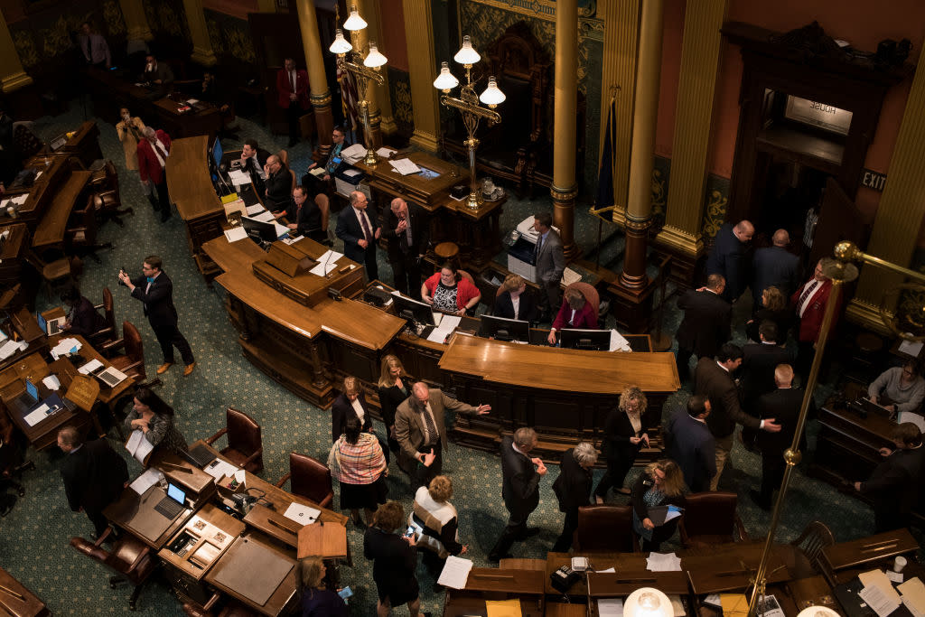 Lawmakers exit the floor as Flint residents and allies from regions nearby disrupt the state legislature with a chant in protest of the closing water distribution sites at the Michigan State Capitol on April 11, 2018 in Lansing, Michigan. (Photo by Brittany Greeson/Getty Images)